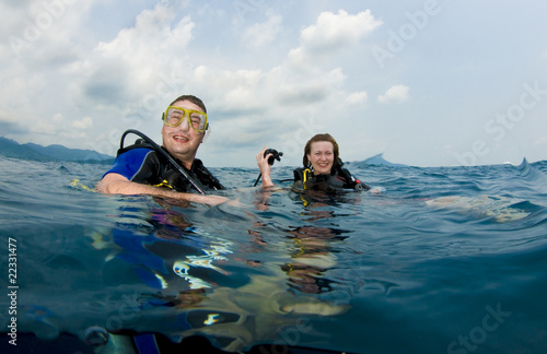 couple scuba diving on surface