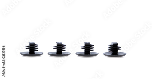 Four black plastic rivets isolated on white