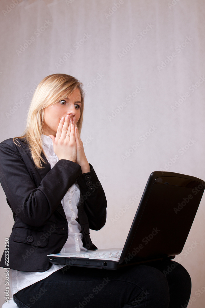 Scared business young woman with laptop Scared business young woman with laptop
