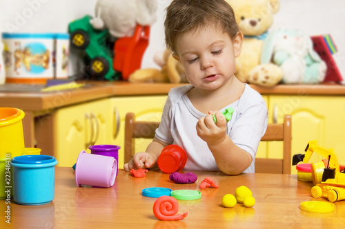 Little child playing plasticine