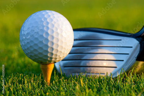 Close up of golf ball and club on golf course