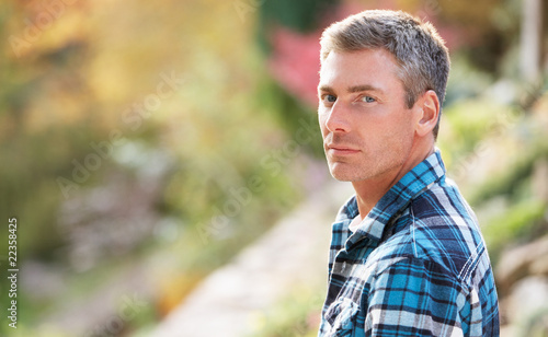 Portrait Of Man Standing Outside In Autumn Landscape