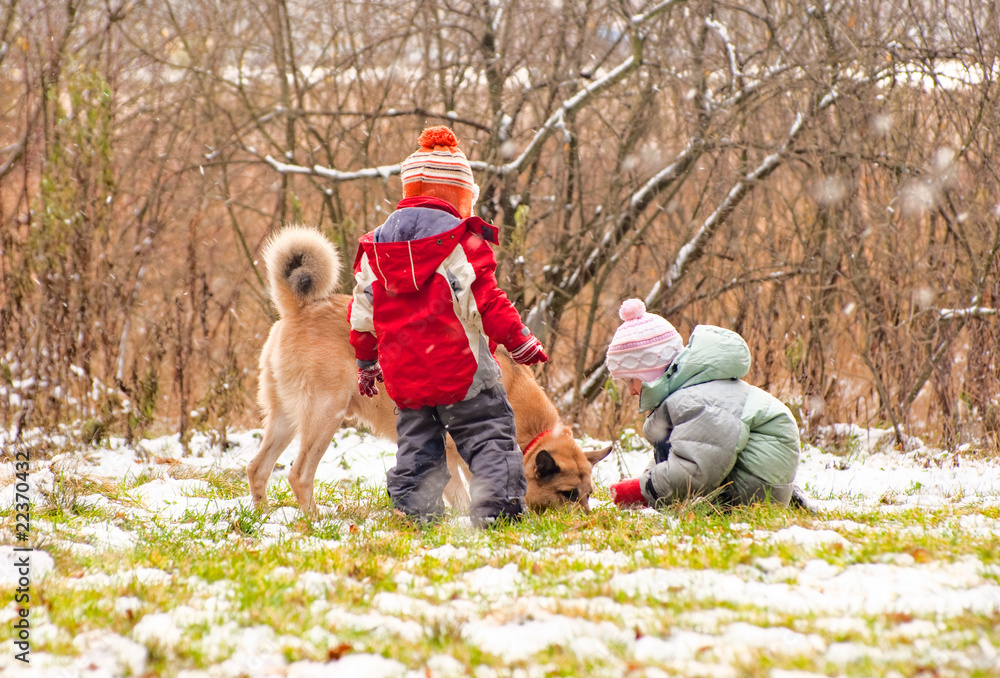 First snow. Little boy and girl playing with dog. First snow. Little boy and girl playing with dog.