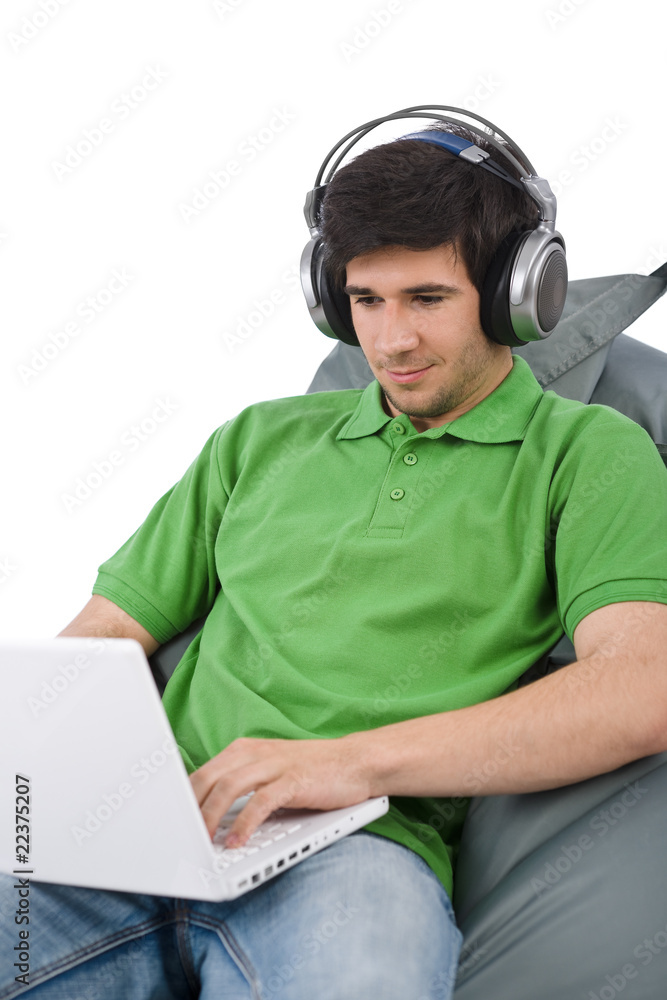Young man with laptop and headphones sitting Young man with laptop and headphones sitting