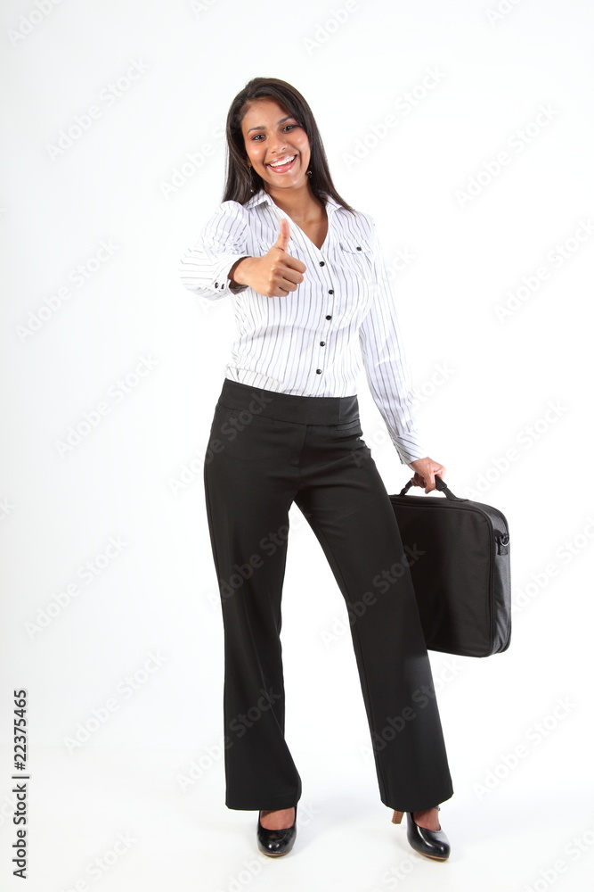 Smiling young business woman giving thumbs up for a great job Smiling young business woman giving thumbs up for a great job