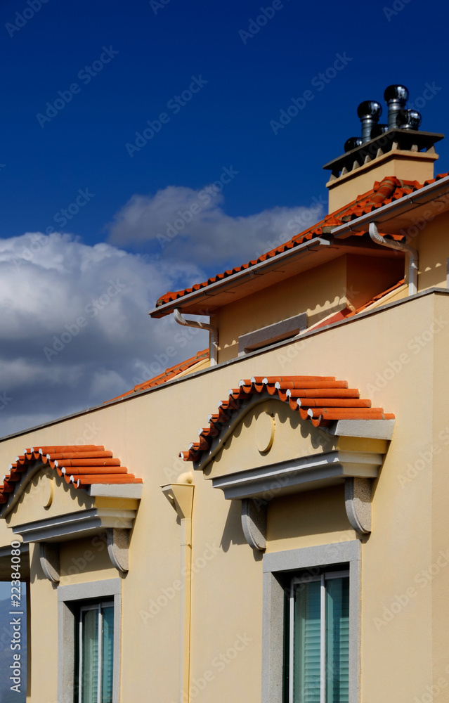 Modern tile roof against the blue sky