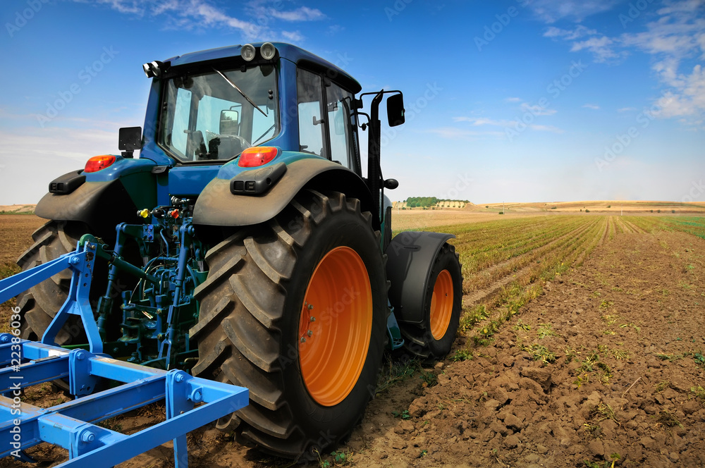 Fototapeta premium The Tractor - modern farm equipment in field