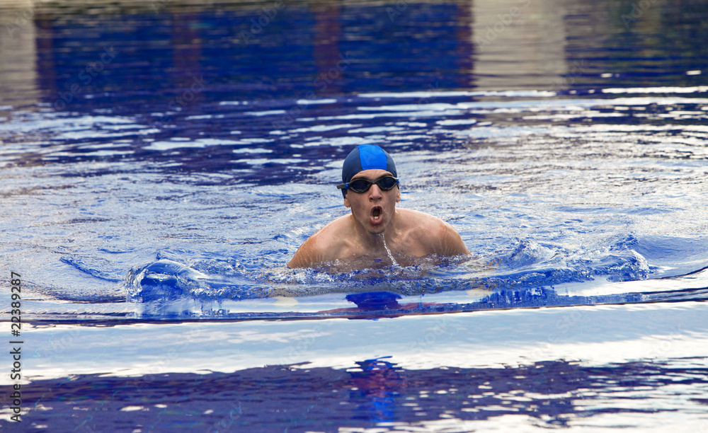 The young sports swimmer in pool