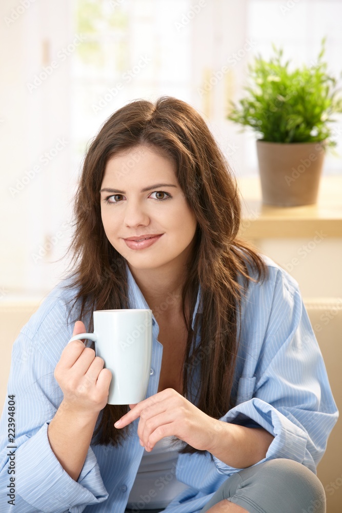 Young woman drinking morning coffee Young woman drinking morning coffee