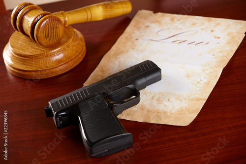 Judges gavel with gun and very old paper