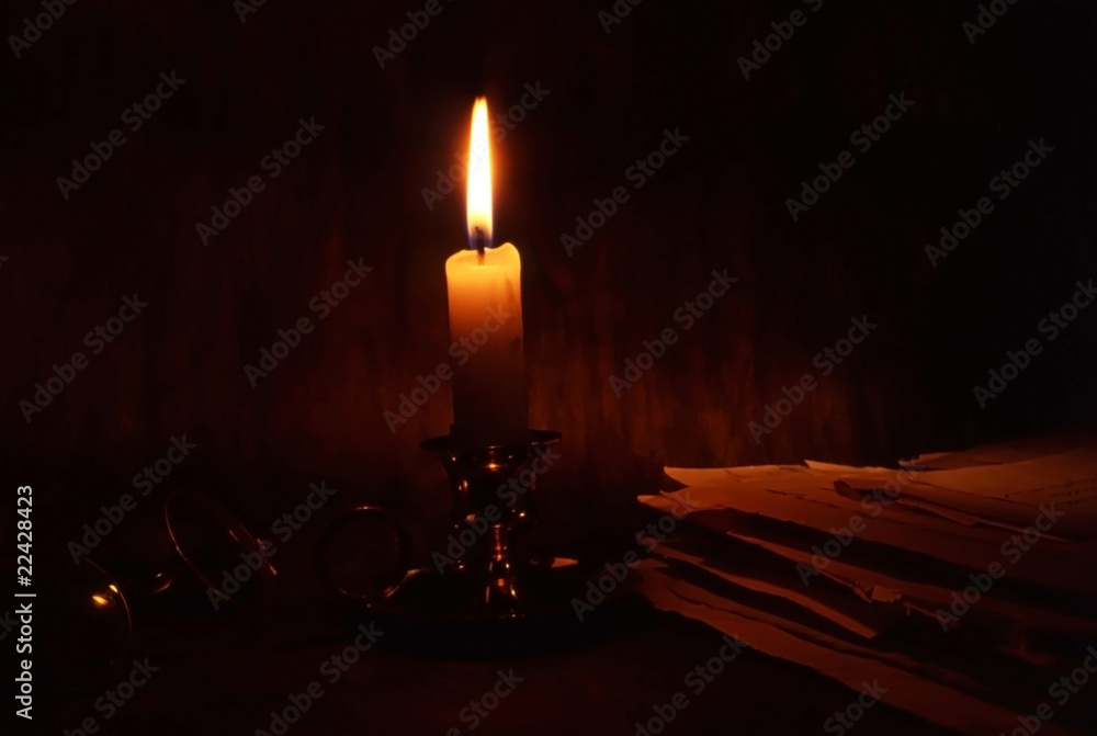 old documents and a candle old documents and a candle