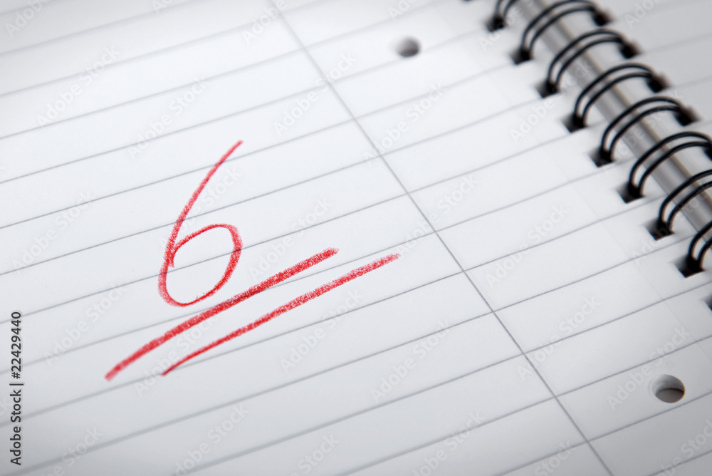 underlined mark six written on a spiral pad underlined mark six written on a spiral pad