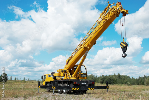 mobile crane with risen boom outdoors photo