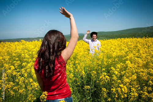 young man and woman in yellow field