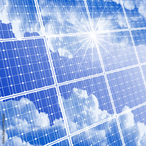 Solar panel with reflection of clouds, clear sky and bright sun