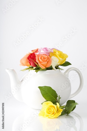 teapot with a fresh roses