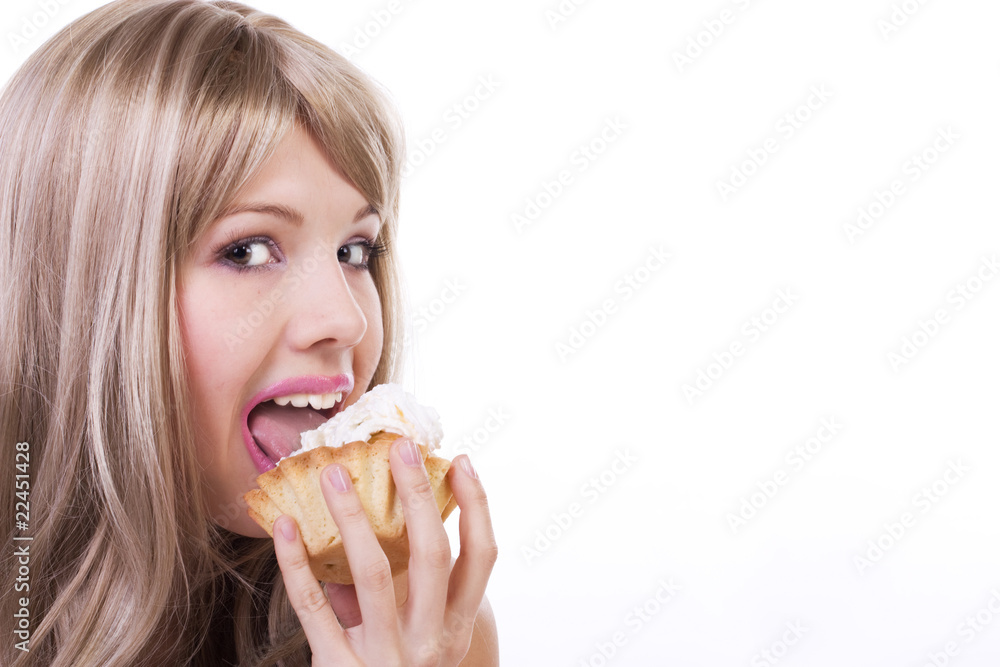 Attractive woman eating a cake. Isolated on white