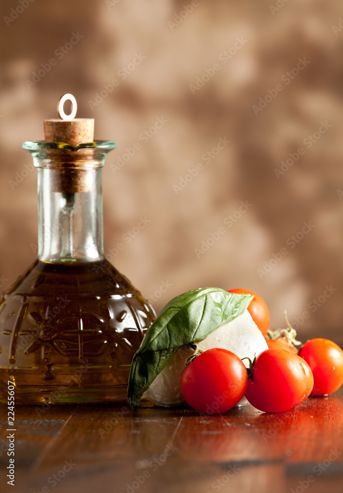 Naklejka Mozzarella with tomatoes and oil