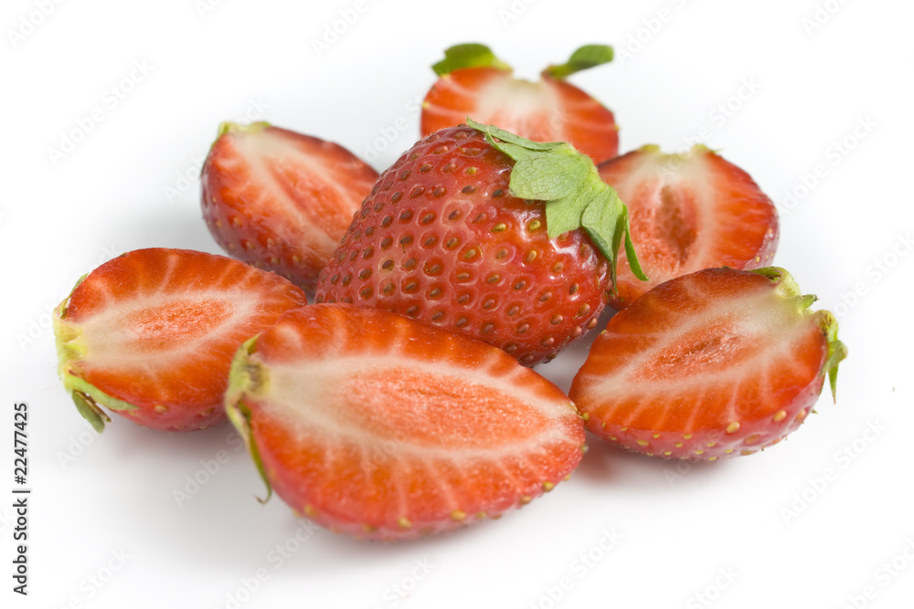 whole strawberry and the berries of a strawberry cut on halves. whole strawberry and the berries of a strawberry cut on halves.