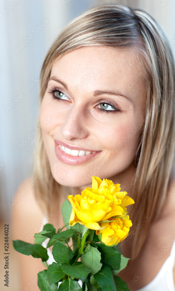 Portrait of a charming woman holding yellow roses