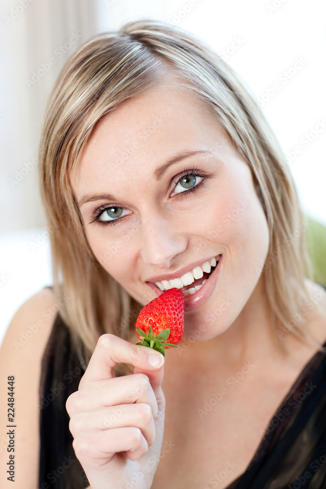 Radiant woman eating a strawberry Radiant woman eating a strawberry