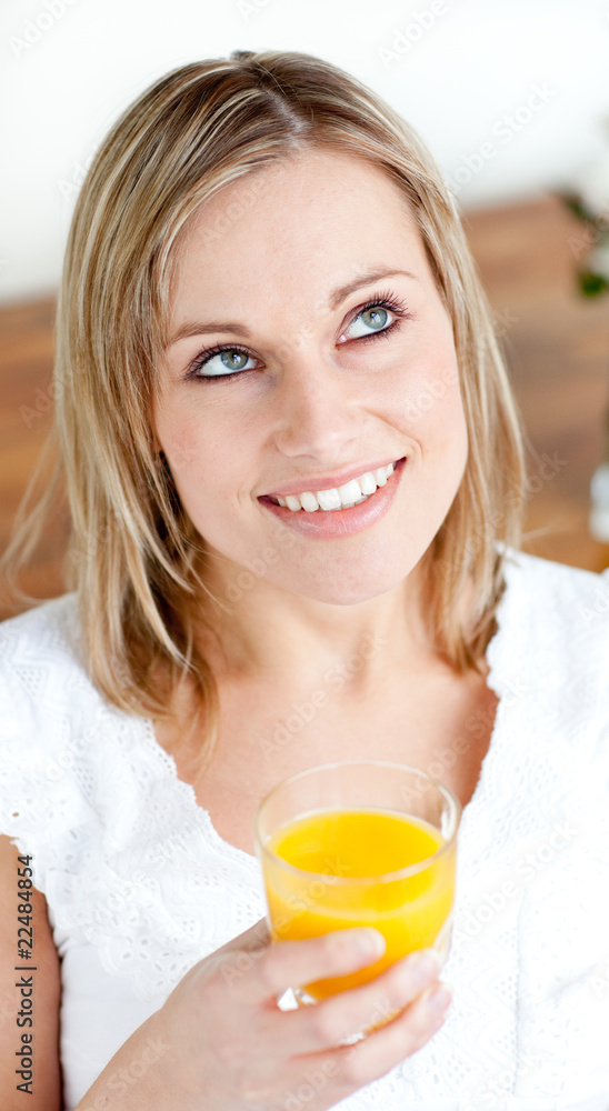 Portrait of a radiant woman holding an orange juice Portrait of a radiant woman holding an orange juice