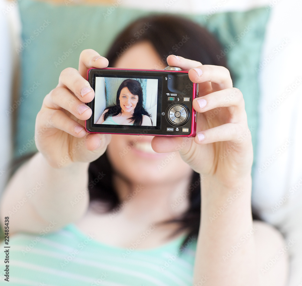 Young woman taking a photo of herself Young woman taking a photo of herself