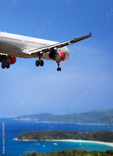 Airplane landing on tropical country