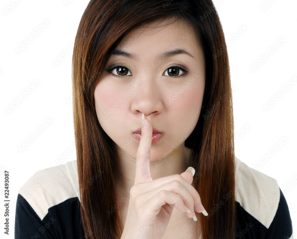 Attractive young woman with finger on her lips Attractive young woman with finger on her lips