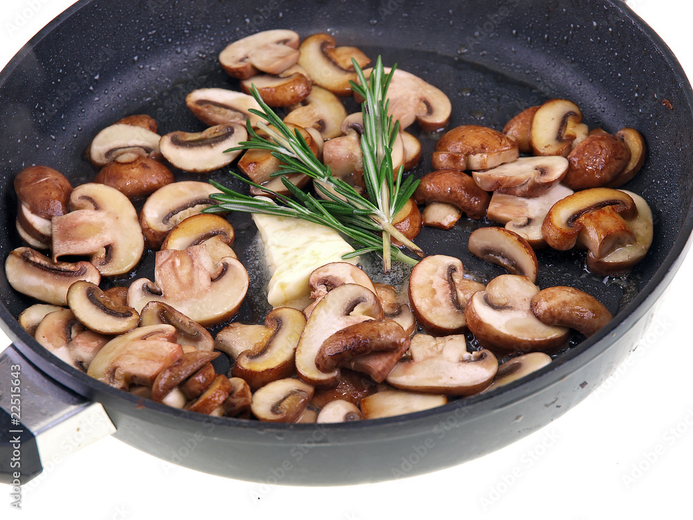 sauteed champignon, butter & herb in a pan isolated on white sauteed champignon, butter & herb in a pan isolated on white