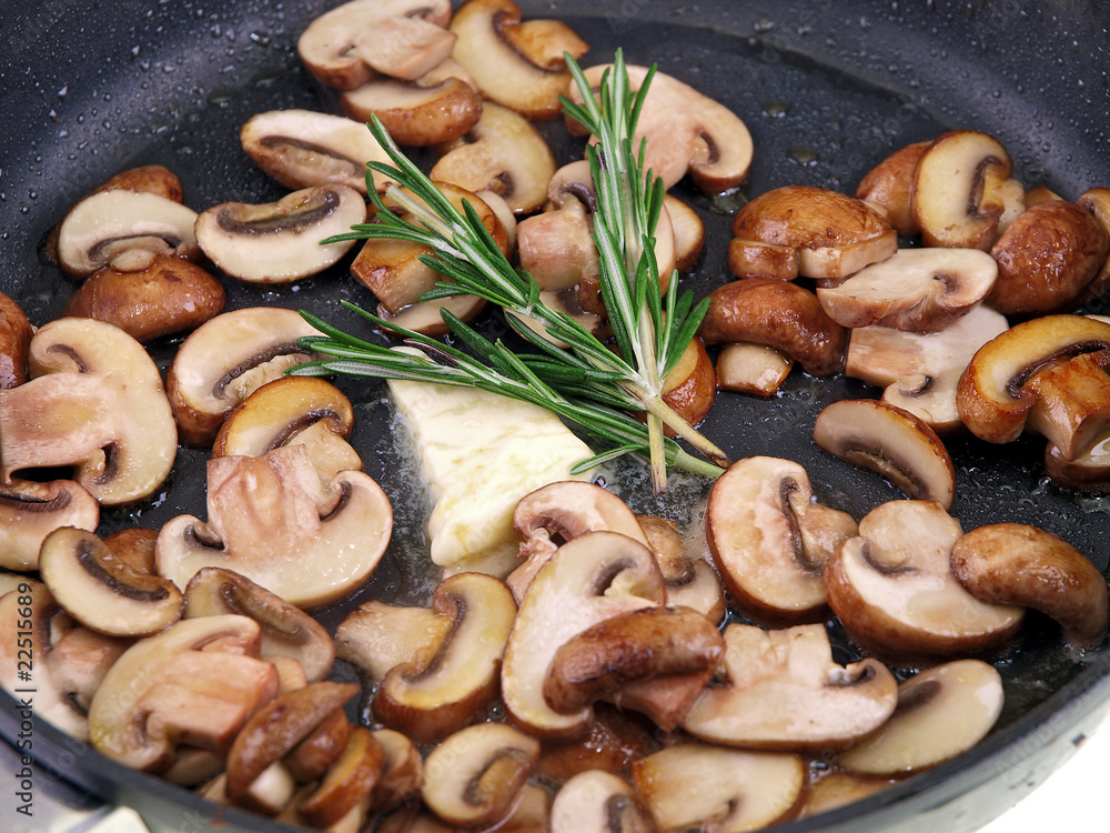 cooking champignon, butter & herb in a pan isolated on white cooking champignon, butter & herb in a pan isolated on white