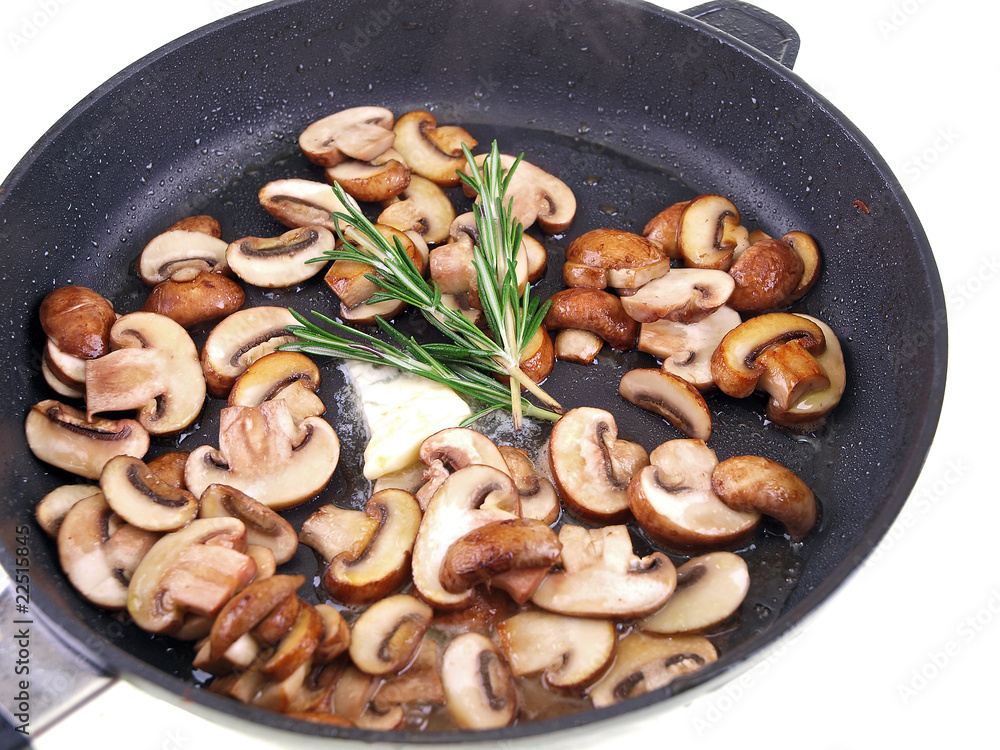 braised champignon, butter & herb in a pan isolated on white braised champignon, butter & herb in a pan isolated on white