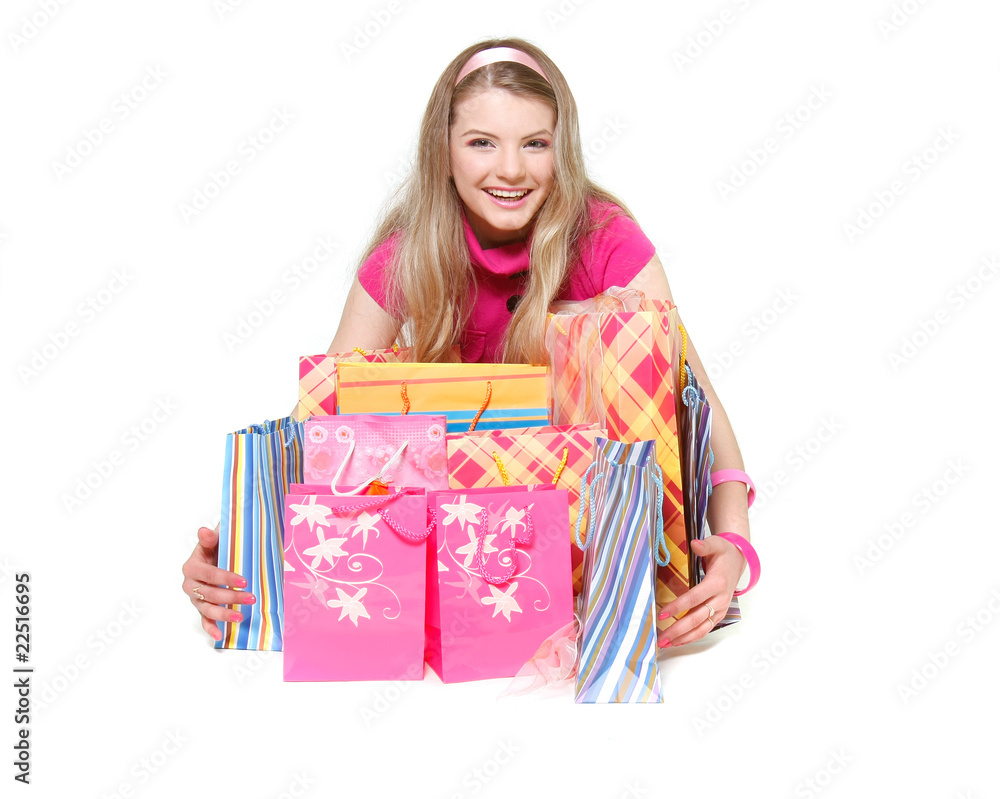 young happy girl with shopping bags over white young happy girl with shopping bags over white