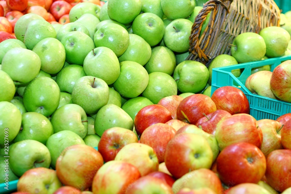 Green and red apples in market