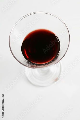 Red wine in wineglass isolated on white background ..