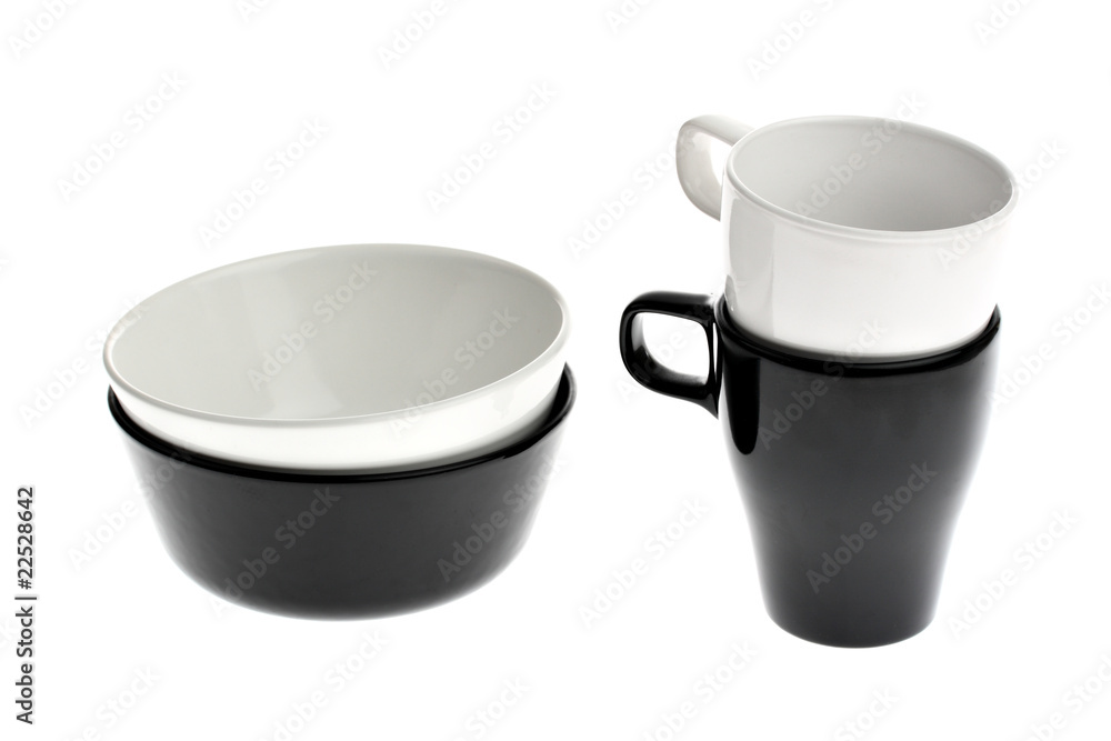 Two black and white ceramic bowls and cups isolated on white Two black and white ceramic bowls and cups isolated on white