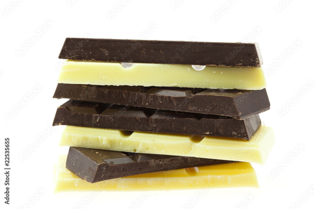Mount pieces of white and dark chocolate isolated on white Mount pieces of white and dark chocolate isolated on white