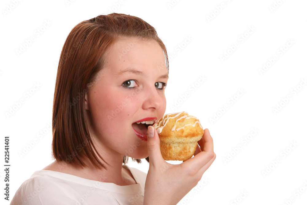 Pretty teenage girl eating muffin