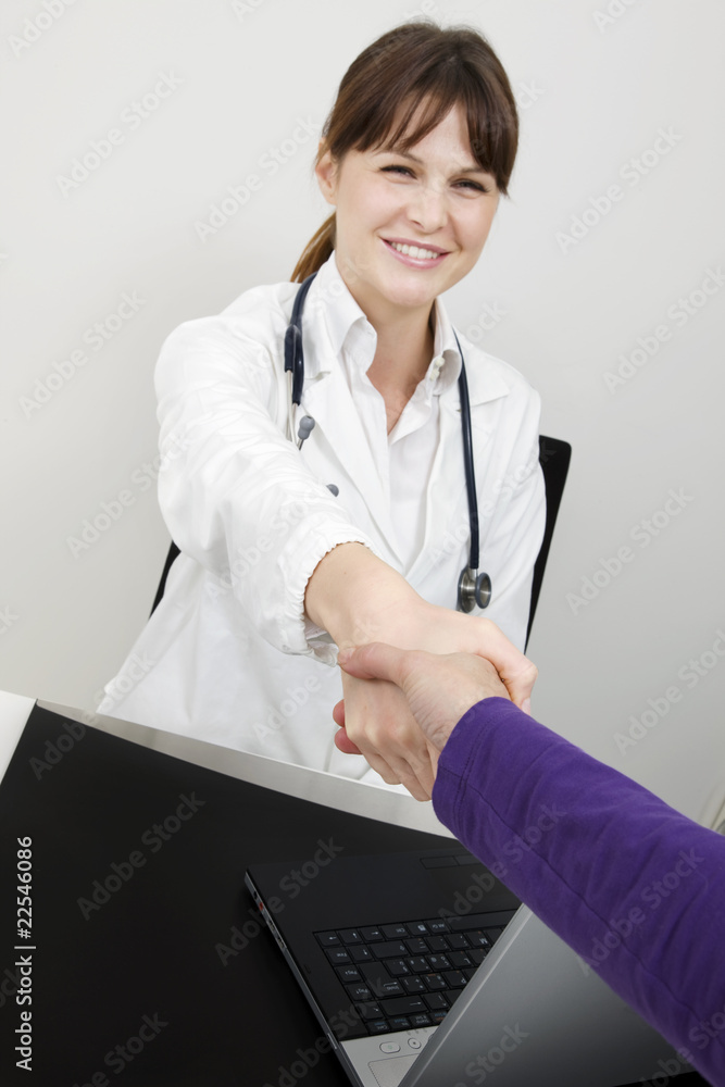 young caucasian woman doctor and patient shake hands young caucasian woman doctor and patient shake hands