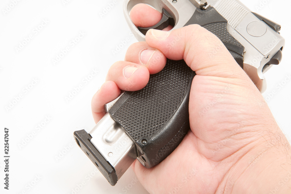 Magazine being removed from handgun Magazine being removed from handgun