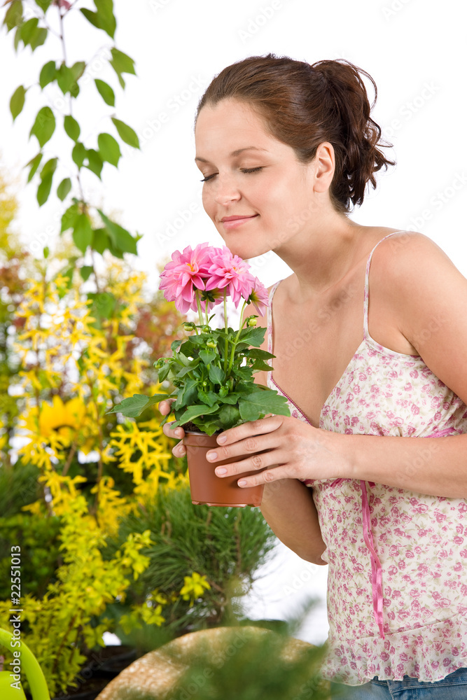 Gardening - woman holding flower pot smelling flower Gardening - woman holding flower pot smelling flower
