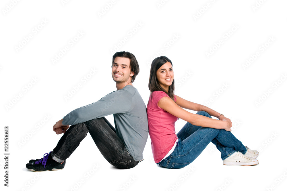 Smiling young couple sitting together Smiling young couple sitting together