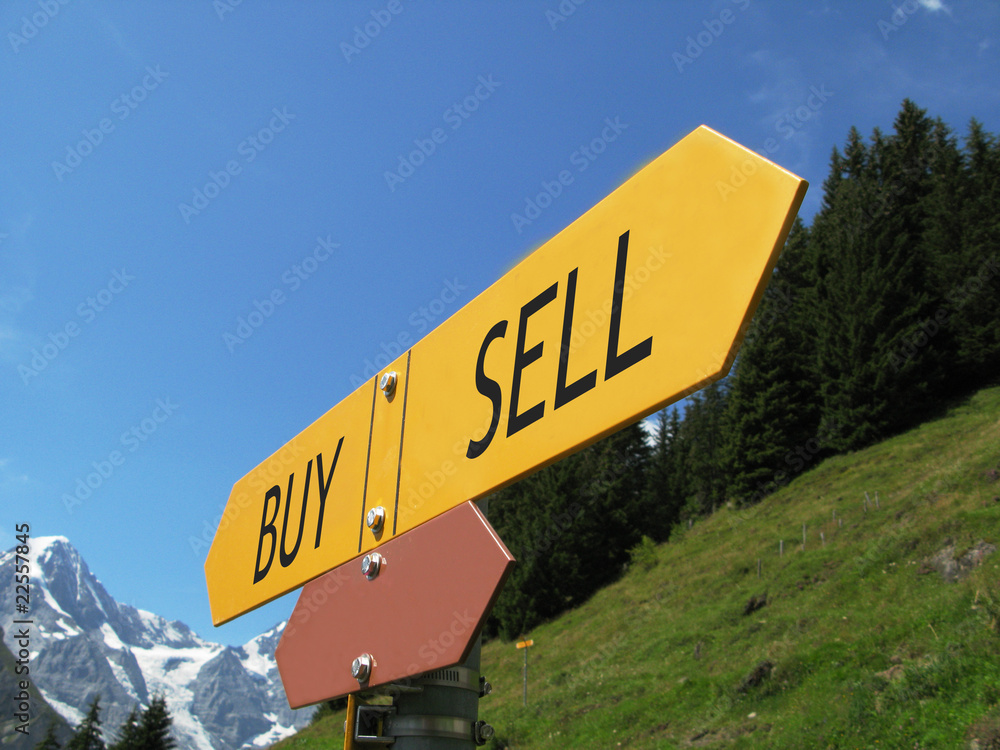 BUY-SELL sign against alpine scenery