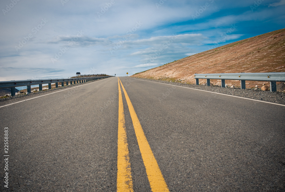 Fototapeta premium vibrant image of highway and blue sky