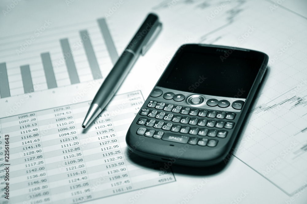 Pen and cell phone on a market report Pen and cell phone on a market report