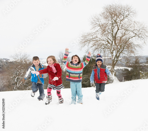 Group Of Children Having Fun In Snowy Countryside
