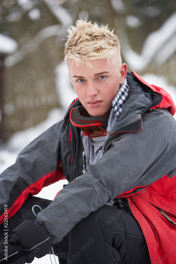 Teenage Boy Wearing Winter Clothes In Snowy Landscape Teenage Boy Wearing Winter Clothes In Snowy Landscape