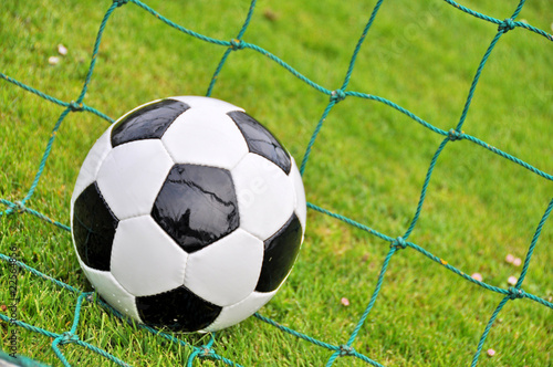 Soccer ball at the goal net © pincasso