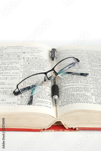 dictionary & pen with glasses