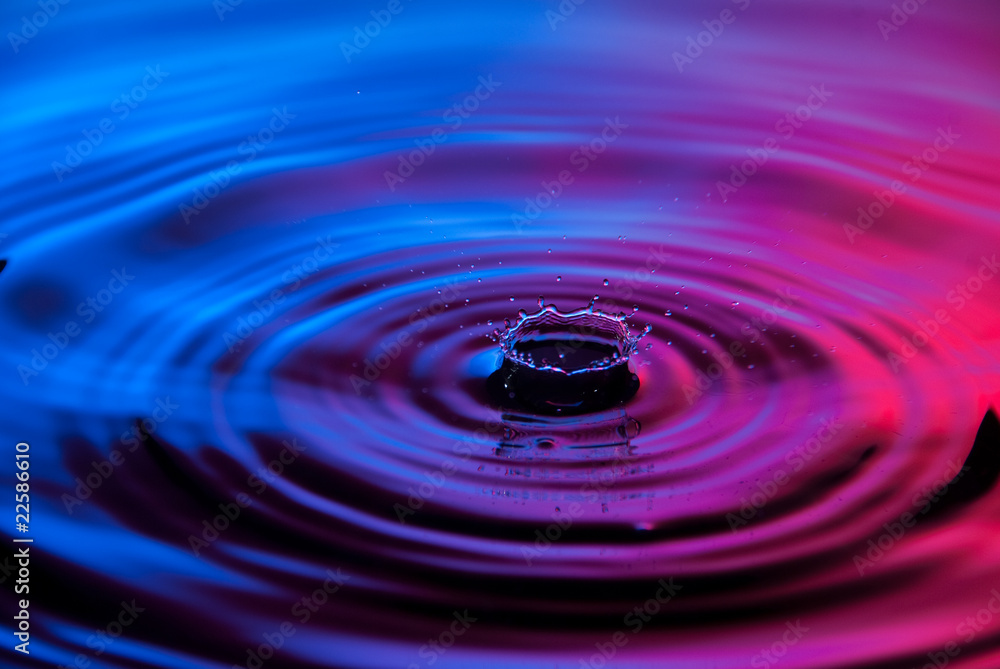 Water drops into red and blue pool Water drops into red and blue pool